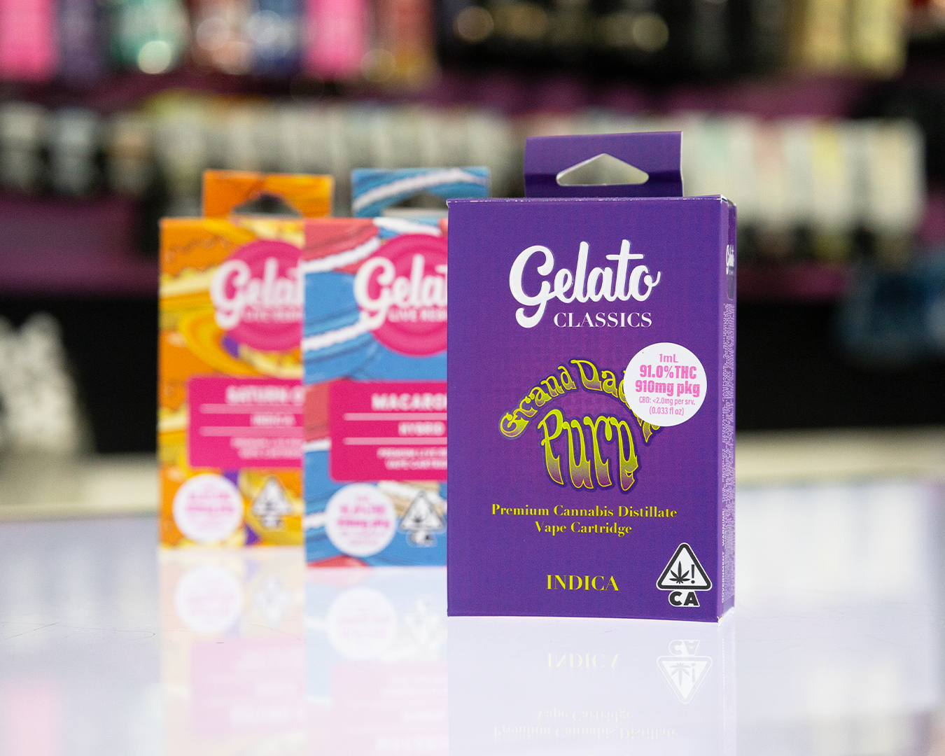 Gelato Classics Grand Daddy Purp indica vape cartridge box with 91% THC, displayed on a dispensary counter alongside other Gelato cannabis vape products.